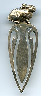 This bookmark was made in the US by Rogers, Lunt and Bowlen. It is marked with the manufacturers hallmark and sterling and the number 168. The top is a figural rabbit.