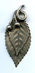 This bookmark was made in the US by Gorham. It is marked with the Gorham hallmark, Sterling, a date mark and number 59. It is in the shape of two leaves and two berries. This is from the Autumn 1888 Gorham catalog where they sold 33 different bookmarks.  
