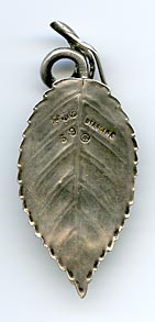 This bookmark was made in the US by Gorham. It is marked with the Gorham hallmark, Sterling, a date mark and number 59. It is in the shape of two leaves and two berries. This is from the Autumn 1888 Gorham catalog where they sold 33 different bookmarks.  