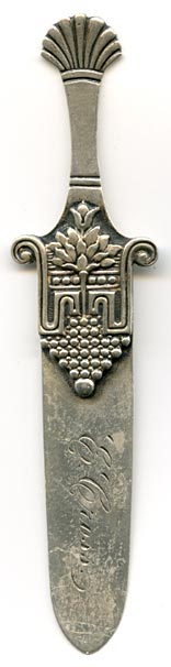 This bookmark was made in the US by Gorham. It is marked with the Gorham hallmark and Sterling and 53. The top is a blooming flower in a container. The very top has a shell motif. This is from the Autumn 1888 Gorham catalog where they sold 33 different bookmarks. The year mark on this particular piece is a rooster indicating 1890. 