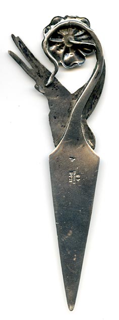 This bookmark was made in the US by Gorham Mfg. Company. It is marked with the manufacturers mark, sterling and 48, the number from the catalogue. This particular bookmarks has the rooster date mark indicating 1890. The top has a highly detailed hummingbird and flower with the wing of the bird forming the top blade. 