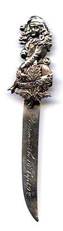 TThis bookmark was made in Canada by P. W. Ellis. It is marked sterling with the manufacturers mark on the back. The Top is a girl dressed for winter, a maple leaf with a banner across it saying "Miss Canada". The blade is inscribed Yarmouth 16 Sep 92. Yarmouth is in Nova Scotia.