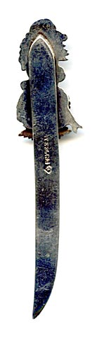 TThis bookmark was made in Canada by P. W. Ellis. It is marked sterling with the manufacturers mark on the back. The Top is a girl dressed for winter, a maple leaf with a banner across it saying "Miss Canada". The blade is inscribed Yarmouth 16 Sep 92. Yarmouth is in Nova Scotia.