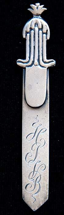 This is an American made bookmark. The manufacturer is Gorham. It is marked with the manufacturers hallmark, Sterling and the catalog number 39.  The top has an acorn design. It's nicely detailed. It is from the Autumn 1888 Gorham Catalog (although the date mark on this particular bookmark is from 1890). It is one of 33 different bookmarks offered that year.