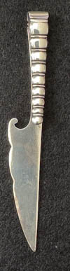 This is an American made bookmark. The manufacturer is Gorham. It is marked with the manufacturers hallmark, Sterling and the catalog number 45. It is shaped like a knife with a beaded handle. It is from the Autumn 1888 Gorham Catalog. It is one of 33 different bookmarks offered that year.