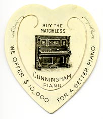 This bookmark was made in the US by Meek Company of Coshocton, D. It is a celluloid advertising bookmark for Cunningham pianos. It is in the shape of a heart with blue flowers along the outside edge. On the back is a picture of an upright piano with the words, 'Buy the Matchless Cunningham Piano. We offer $10,000 for a better piano.'" The date is 1900 - 1915."