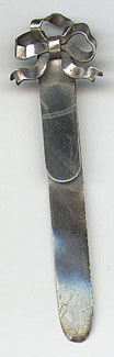 This is an American made bookmark. The manufacturer is Thomas F. Brogan and was made between 1896 and 1930. It is marked Sterling with the manufacturers mark (which is a five pointed star). The top of the bookmark is a silver bow.