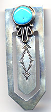 This bookmark is made in the US by a native American tribe. It has a turquoise stone on the top and is marked Many goats, sterling on the back.