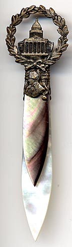 This bookmark was made in France as a souvenir of the Musee de L'Armee. It is brass, abalone and mother-of-pearl.  The top has a bust of Napoleon and a wreath surrounding a building labeled Paris. The building is the Musee de L'Armee, located at the Invalides in Paris, France. Originally built as a hotel for disabled soldiers (Invalides) by Louis XIV, it now houses the Tomb of Napoleon 1st and the museum of the Army of France.