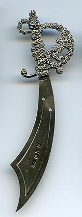 This bookmark was made made at Halifax in Yorkshire, England. It is in the shape of a sword with a fancy hilt. the date is 1898.