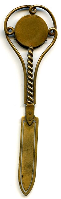 This bookmark was made in France. It is brass and the top is a relief picture of an owl with yellow glass eyes. The date is 1890 - 1910. 