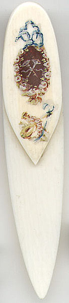 This bookmark is either bone or ivory. It has hand painted flowers and musical instruments on the top. It is American made by an unknown manufacturer sometime in the 1930's.