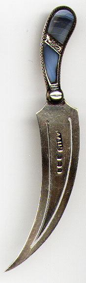 This bookmark was made in Birmingham, England in 1900. It is marked A&LLd and the marks for Birmingham and the letter a for the date of 1900. It is in the shape of a sickle with the top handle made of a bluish stone.