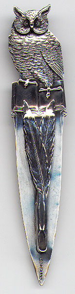 This bookmark was made in the US by an unknown manufacturer. It is marked sterling on the bottom of the larger blade. It is an owl sitting on a book. The smaller blade is two crossed feathers. The date is 1890 - 1900. 