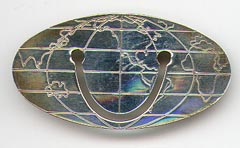 This bookmark was made in the US by Tiffany and Co. It is marked Tiffany & Co. 925 Sterling &copy;. It is a world map in an oval shape. The date is 1980 - 1990