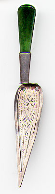This bookmark was made in the US by an unknown manufacturer. It is a Masonic piece in the shape of a trowel with a jade handle. It is marked JS&S Sterling Silver. The date is 1900 - 1910.  