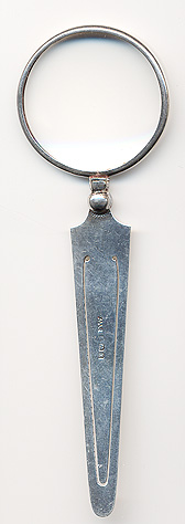 This bookmark was made Birmingham, England. It is made by Adie and Lovekin and is marked with the hallmarks for Birmingham and 1922. The top is a magnifying glass.