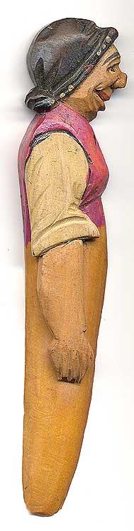 This bookmark was made in Italy by the Anri workshop. It is carved of wood and depicts a woman.