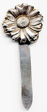  This bookmark is made in the US by Unger Bros. It is marked with the manufacturers hallmark on the back. The top is a flower.  The date is 1900 - 1910.   